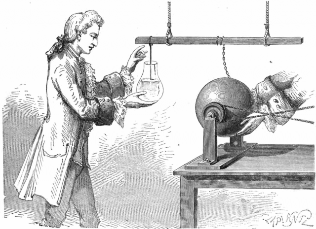 La esfera es un generador electrostático. La carga sube por la cadena y, a través de la barra metálica suspendida, llega al cable introducido en el agua. La imagen representa a Andreas Cuneus justo antes de tocar el cable.